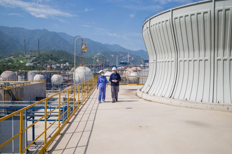 veolia-employees-walking-industrial-cooling-tower